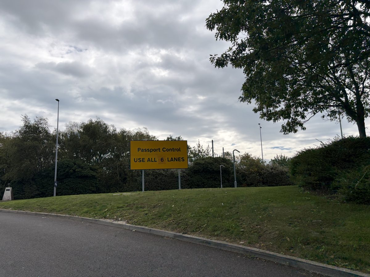 Yellow sign at Folkestone reading Passport Control use all 6 lanes