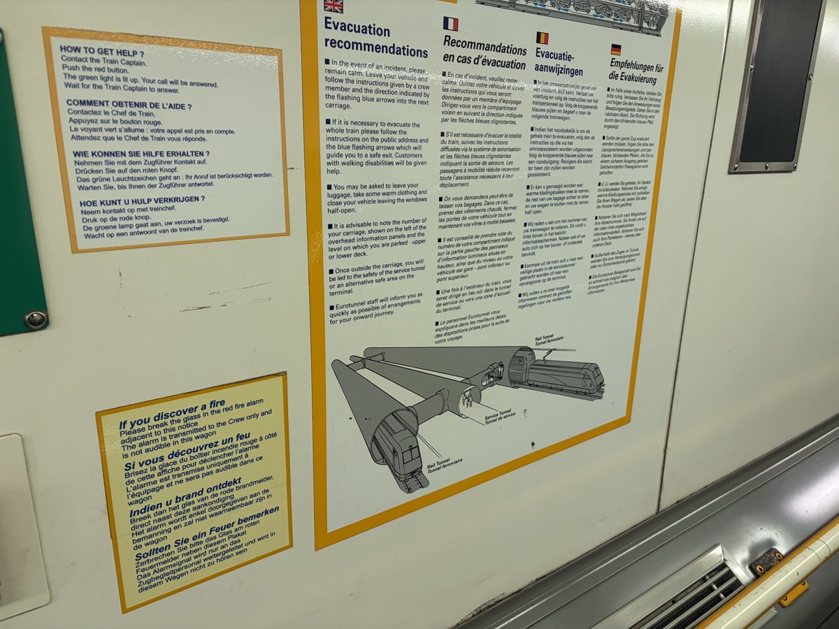 Multilingual evacuation instructions displayed inside a LeShuttle carriage