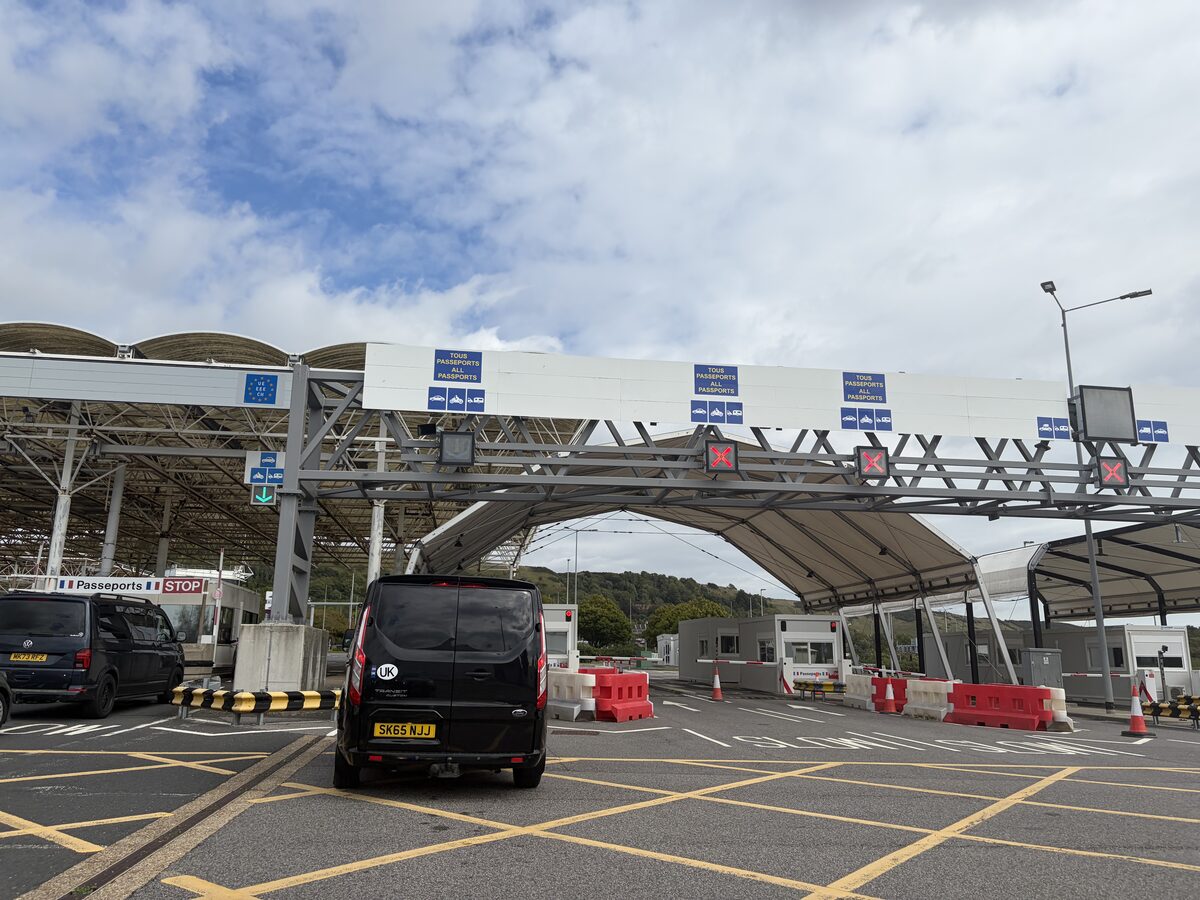 Passport control booths with Passeports Stop sign at the Folkestone terminal