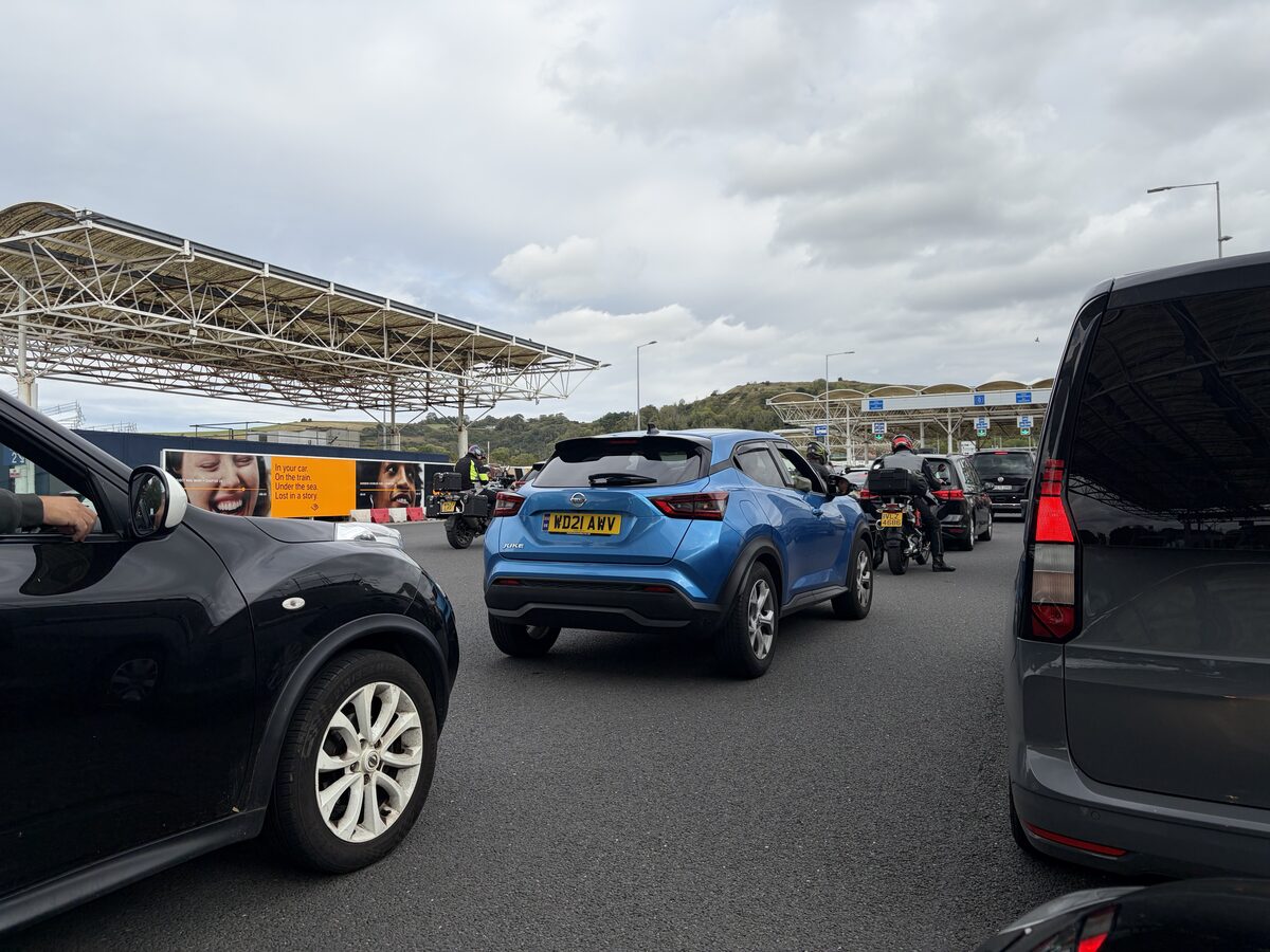 Cars and motorcycles queuing under the canopy at passport control in Folkestone